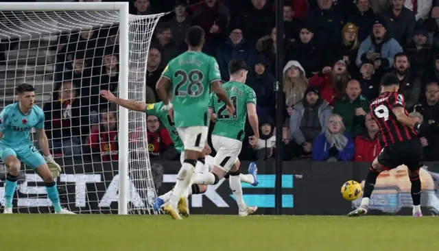 Dominic Solanke shoots with Nick Pope attempting to save it