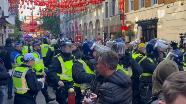 Police officers scuffle with counter protesters in London's Chinatown