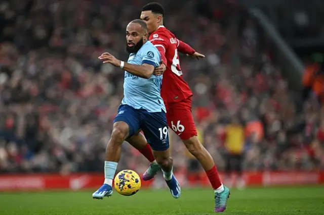 Bryan Mbeumo runs past Trent Alexander