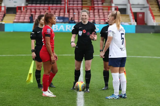 Captains Bartrip and Hinds meet with the ref to conduct the coin toss.