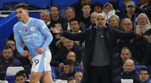 Pep Guardiola looks on from the touchline