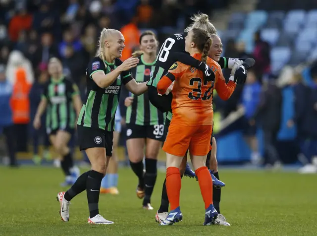 Brighton players run to congratulate their goalkeeper at full time.