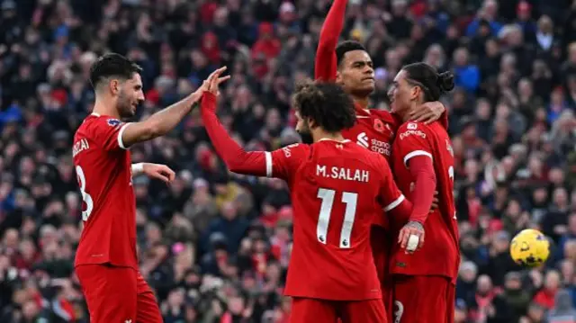 Liverpool players celebrate Salah's goal hugging