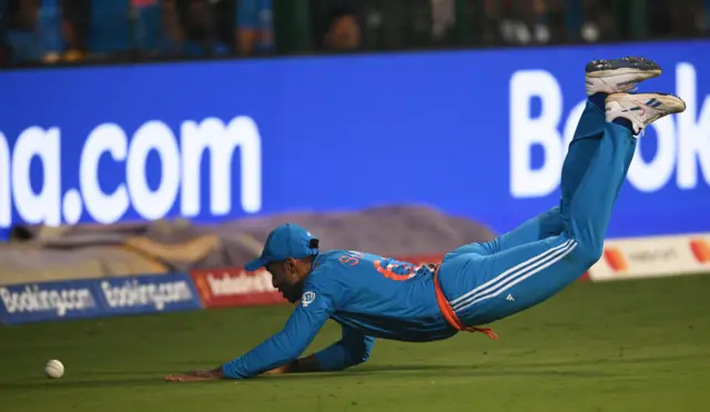 Suryakumar Yadav dives to prevent a boundary