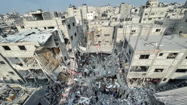 Aerial view of rescuers searching through the rubble of buildings