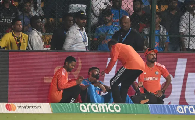 Mohammed Siraj gets treatment on a throat injury