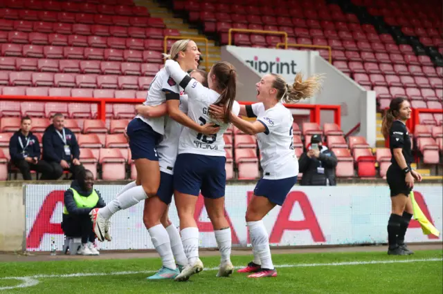 Bizet is mobbed by teammates after opening the scoring.