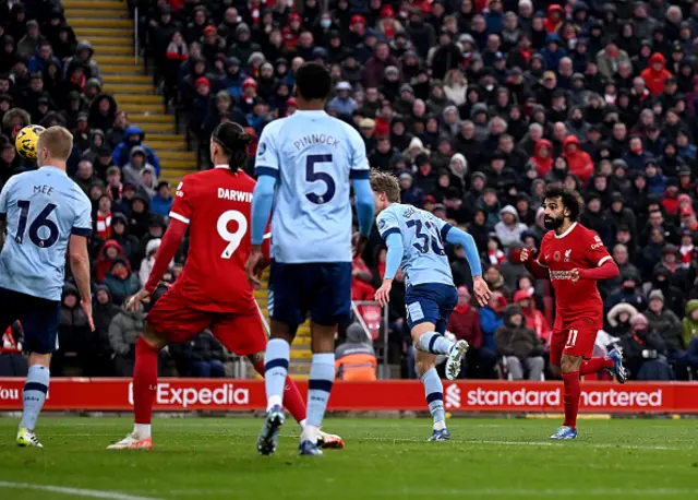 Mohamed Salah looks on after he heads the ball