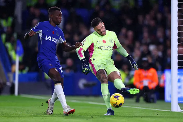 Ederson on the ball under pressure from Jackson