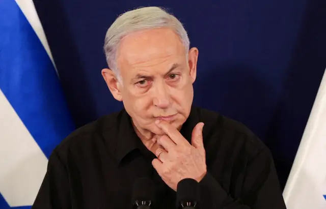 Israeli Prime Minister Benjamin Netanyahu speaks during a press conference with Defense Minister Yoav Gallant and Cabinet Minister Benny Gantz on 28 October