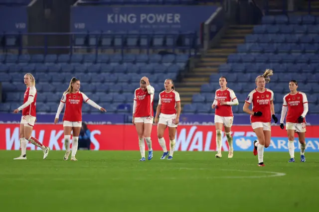 Arsenal players trudge back to kick off after conceding the second Leicester goal.