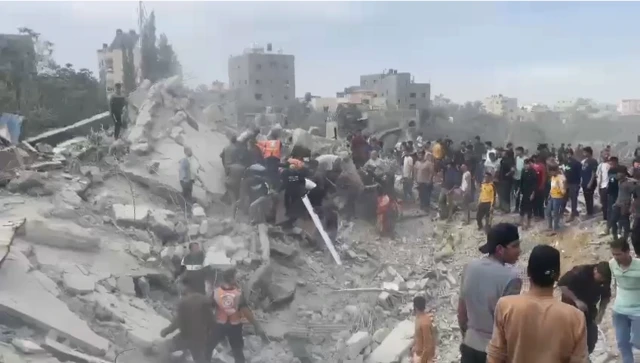 People search through a large mass of rubble following an air strike