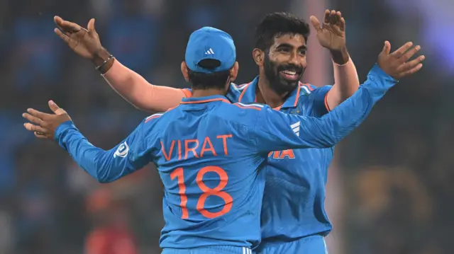 Jasprit Bumrah and Virat Kohli celebrate a wicket