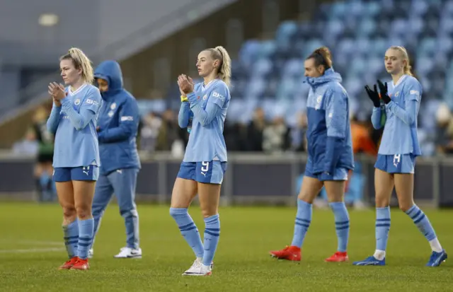 City players applaud the fans with glum faces after suffering a defeat.