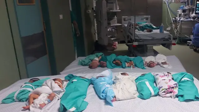 A number of newborn babies lying on beds in a surgical theatre