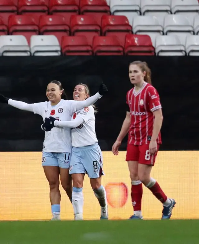 Salmon and Nobbs celebrate as a Bristol defender walks sstaring at the floor in dejection.