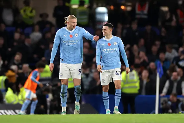 Erling Haaland of Manchester City celebrates with teammate Phil Foden