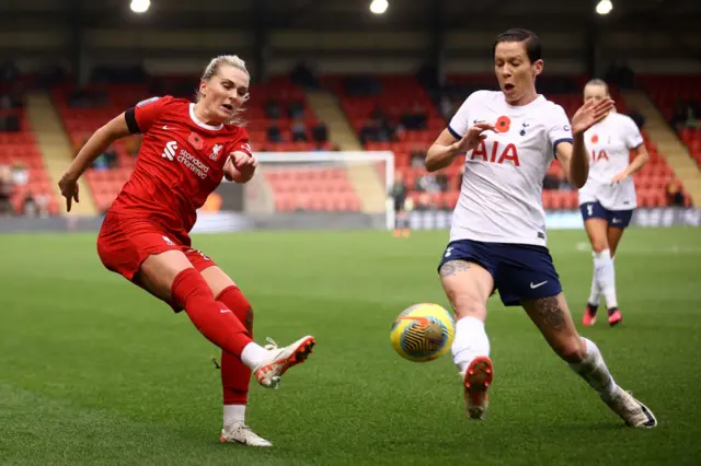 Mel Lawley tries to cross the ball as Ash Neville tries to block.