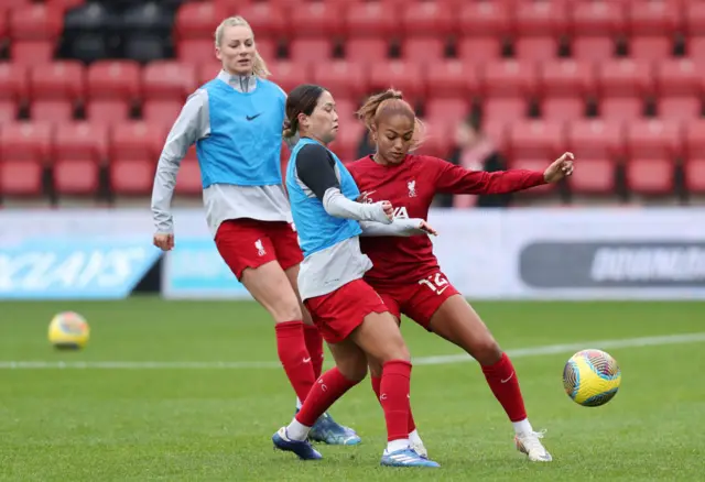 Nagano and Hinds battle for the ball in a warm up drill.