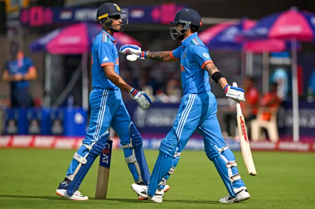 Virat Kohli pats Shubman Gill on the shoulder as he walks out to bat