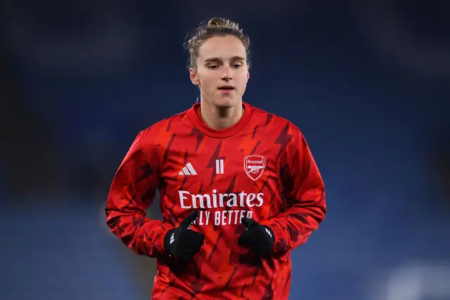 Miedema warms up on the pitch before the game.