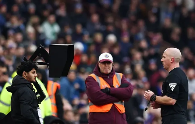 Referee Simon Hopper looks at a VAR for a penalty