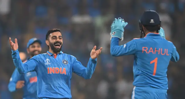 Virat Kohli celebrates with KL Rahul after taking the wicket of Scott Edwards