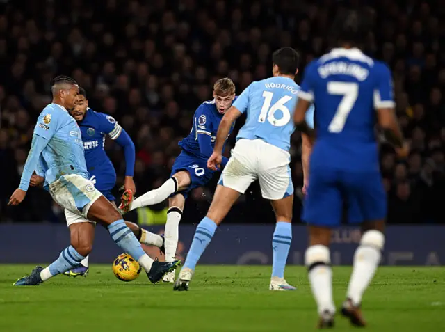 Cole Palmer of Chelsea is challenged by Manuel Akanji