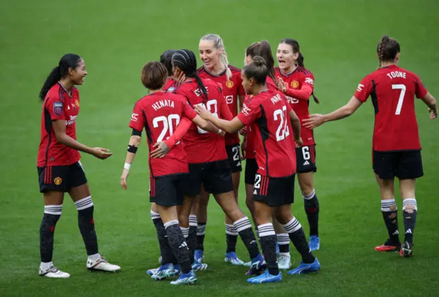 United players gather to celebrate after their next goal.