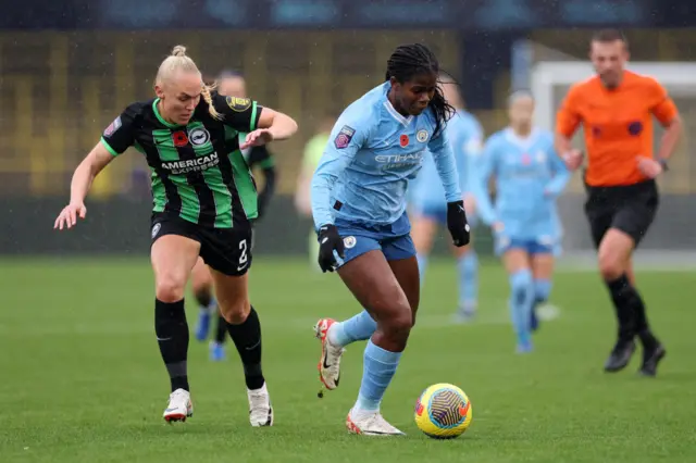 Shaw holds off Thorissdottir as she tries to run forward with the ball.