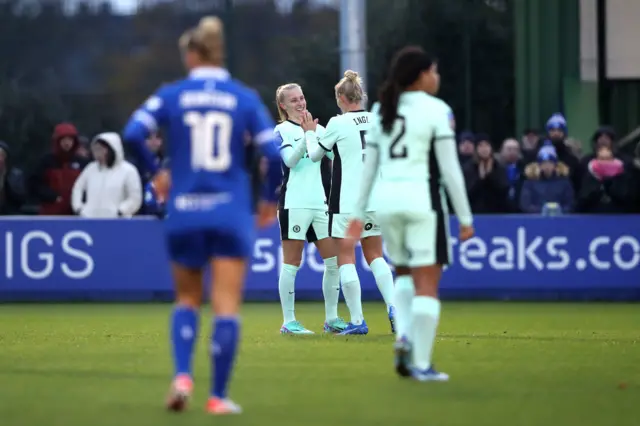 Ingle congratulates Beever-Jones after she adds a third for Chelsea.