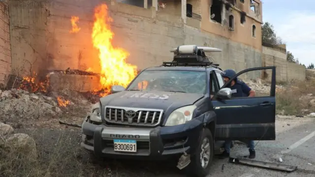 A vehicle which belongs to the press members were damaged by Israel, as a fire breaks out near the car at the Israel-Lebanon border in Yaroun, Lebanon