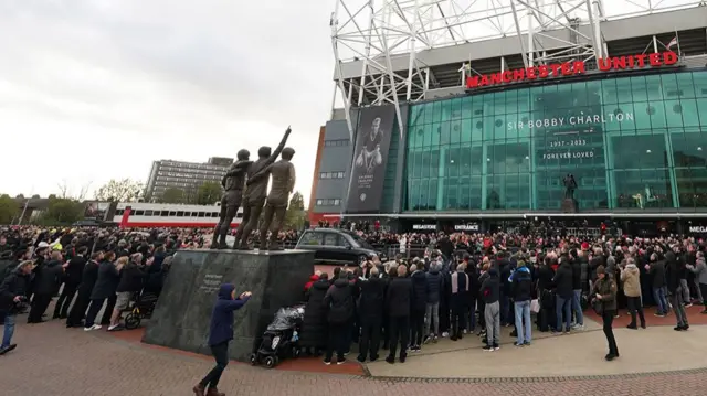 The funeral procession arrives outside Old Trafford