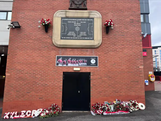 Floral tributes to Sir Bobby Charlton at the Munich memorial at Old Trafford