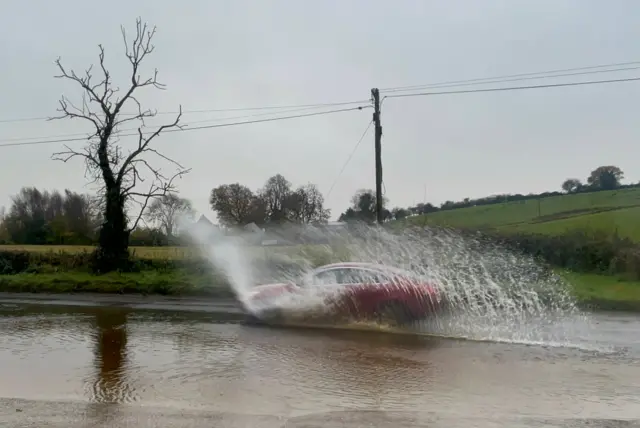 Cars driving through flooded water in Cookstown