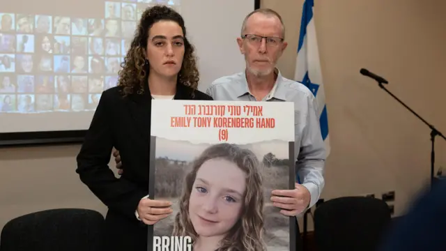 Thomas Hand and Natali Hand hold an image of Emily at the Dublin news conference