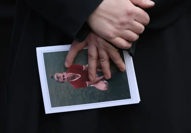 View of the order of service displaying an image of Bobby Charlton