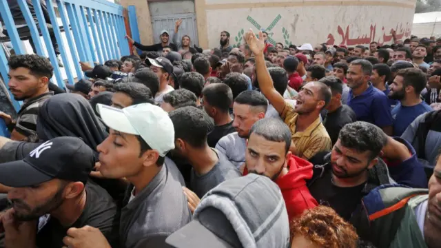 Civilians line up for flour in front of Al Salam Flour Plae Israeli attacks on Gaza continuent, which has difficulty in finding fuel to keep the generators running, after the flour ran out in the markets as th