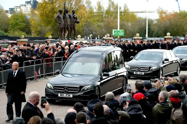 The funeral procession for Sir Bobby Charlton passes Old Trafford