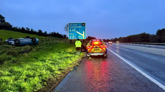 car flipped over on side on motorway