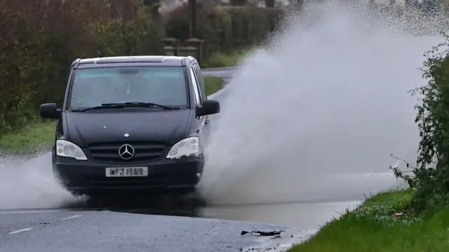 car goes through floods