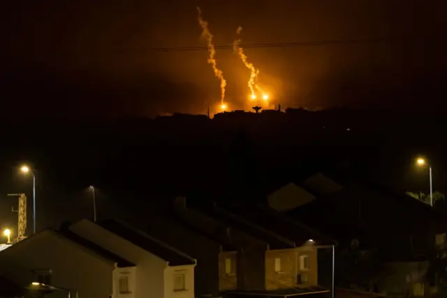 This picture taken from a position near Sderot along the Israeli border with the Gaza Strip early on November 14, 2023, shows flares dropped by Israeli forces above the Palestinian territory amid ongoing battles between Israel and the Palestinian Hamas movement.