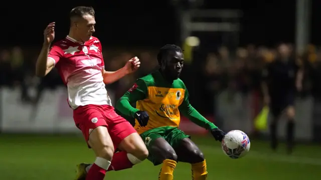 Horsham and Barnsley players challenge for the ball