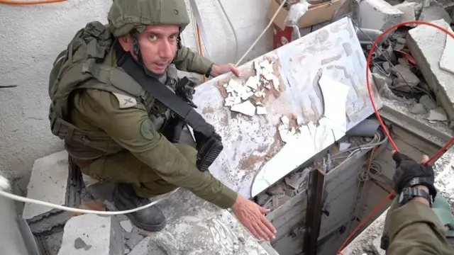 IDF spokesman stands next to purported tunnel shaft