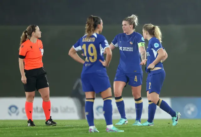 Chelsea players protest the decision to rule out a late goal.