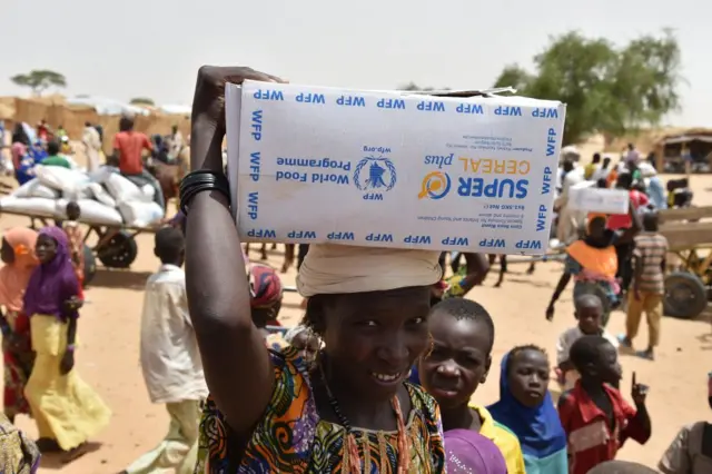 Displaced people fleeing from Boko Haram incursions into Niger attend a World Food Programme (WFP) and USAID food distribution at the Asanga refugee camp near Diffa on June 16, 2016 following attacks by Nigeria-based Boko Haram fighters in the region. Interior minister Mohamed Bazoum was paying a visit in Diffa today, after Boko Haram fighters on June 9 attacked a military post in Bosso in Niger's Diffa region, killing 26 soldiers including two from neighbouring Nigeria, in one of its deadliest attacks in Niger