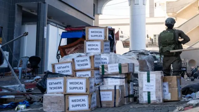 Israeli soldier stands near boxes labelled "Medical Supplies" at the Al Shifa hospital complex, amid their ground operation against Palestinian Islamist group Hamas, during what they say is a delivery of humanitarian aid to the facility in Gaza City, November 15, 2023 in this handout image.