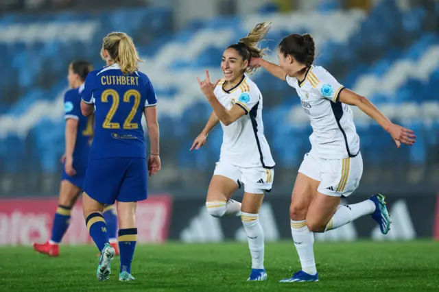 Carmona celebrates her goal with Abelleira as Cuthbert heads back to kick off.