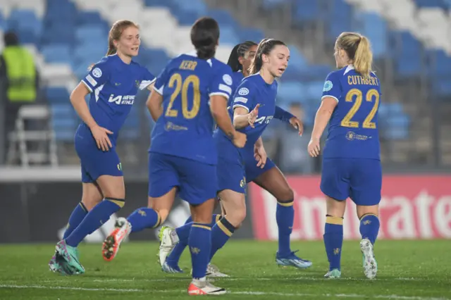 Charles is congratulated by her team mates.