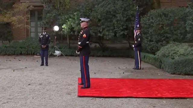 Soldiers wait near red carpet for Biden and Xi to arrive